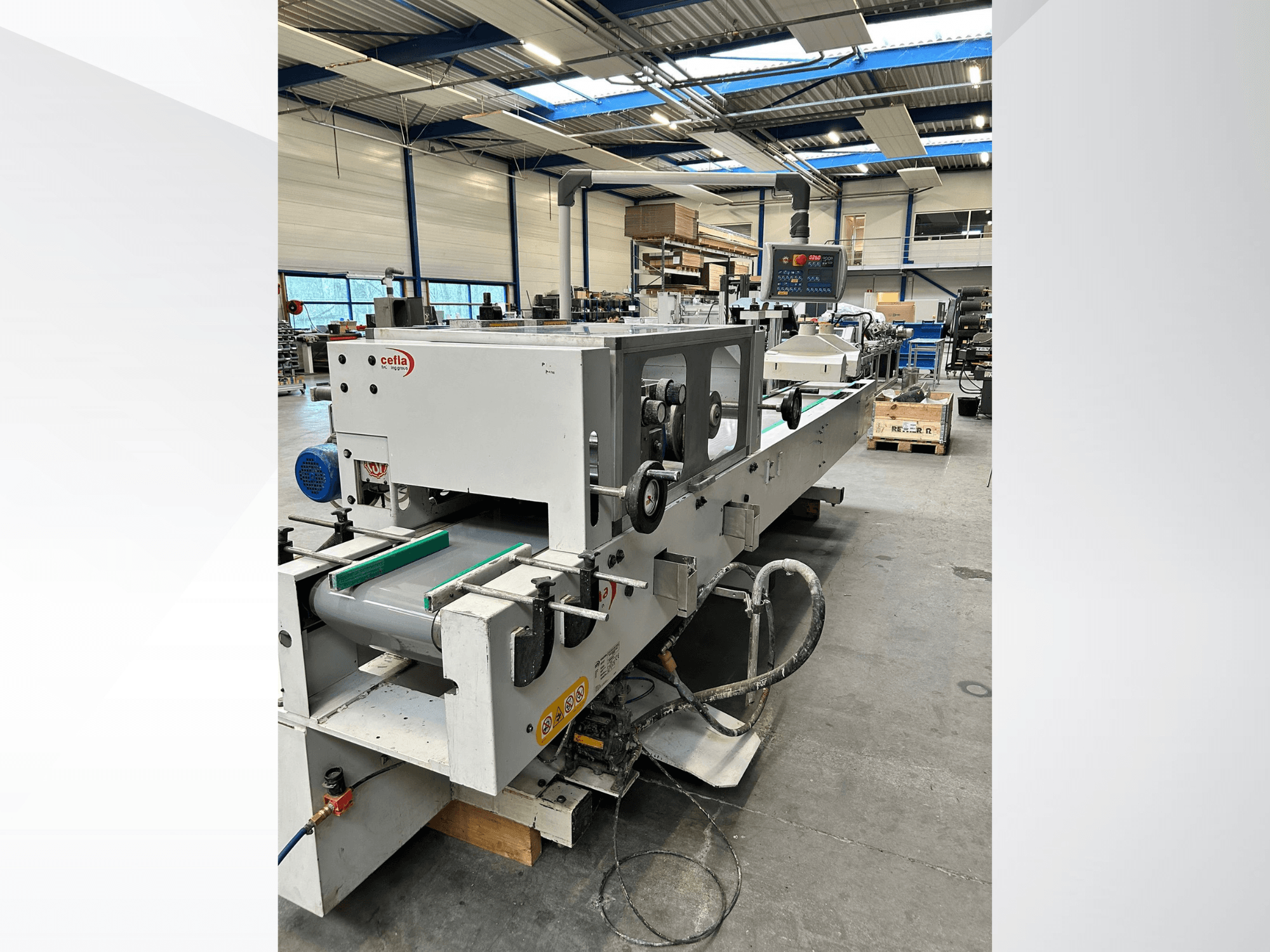 Vista frontal de la máquina para madera CEFLA Smartparquet MRF-2VS/300, en la que se aprecian el panel de control y la cinta transportadora con rodillos verdes.