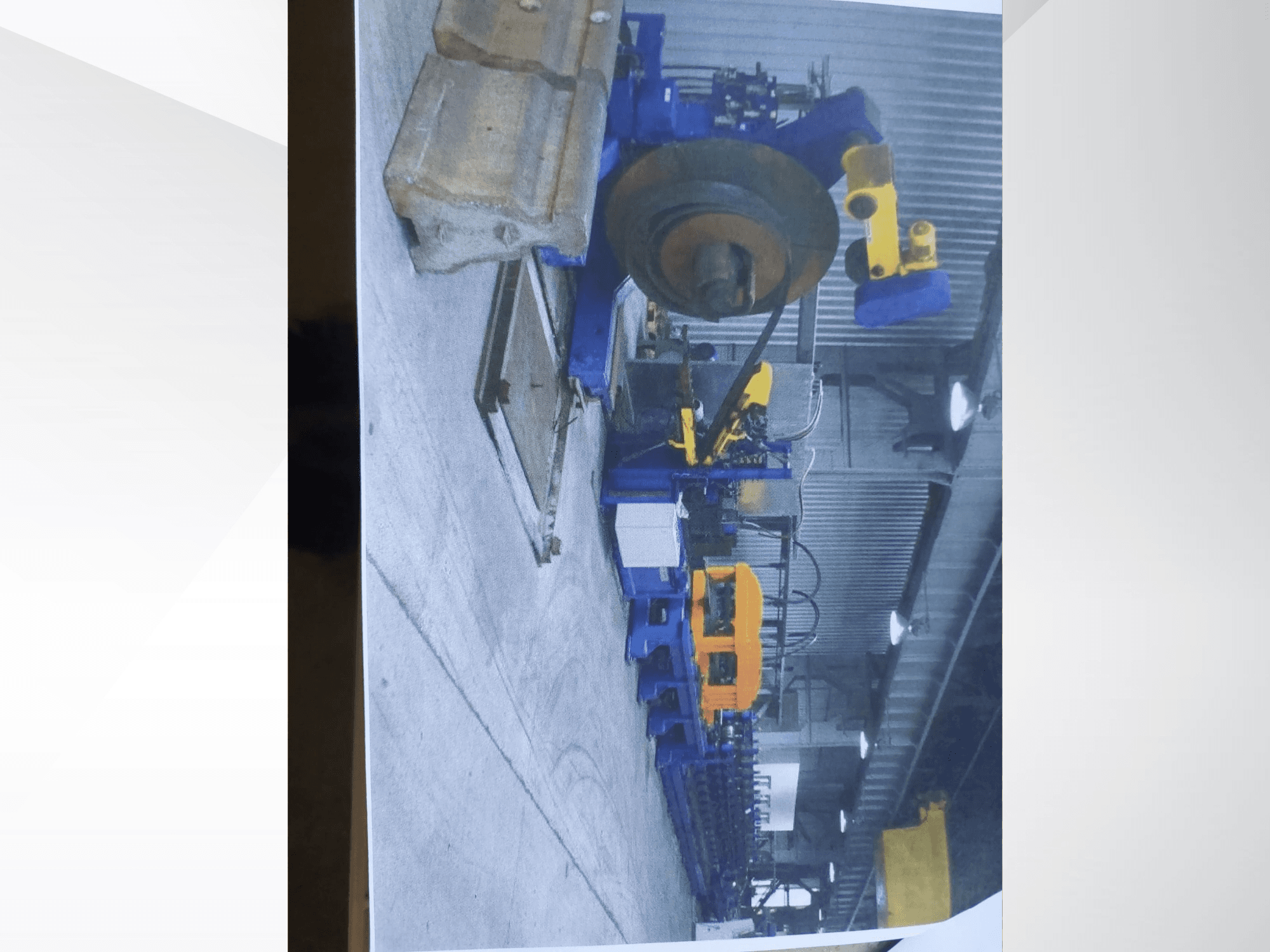 Máquina dobladora de perfiles Müller Profilierung 3 en un taller, en la que destacan la estructura azul y los componentes hidráulicos amarillos.