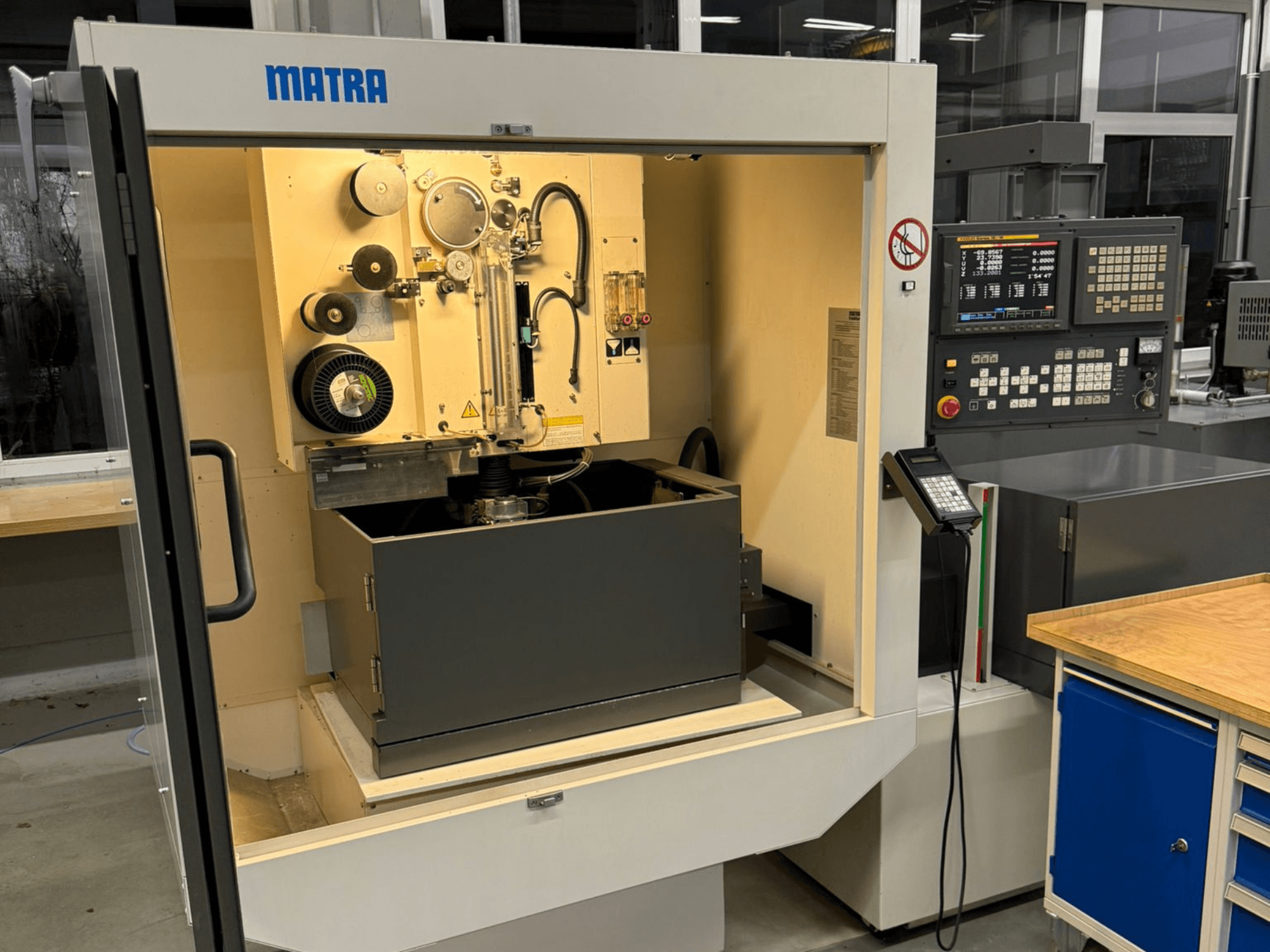 Máquina MATRA vista de frente, con panel de control, piezas giratorias y un gran compartimento de almacenamiento.