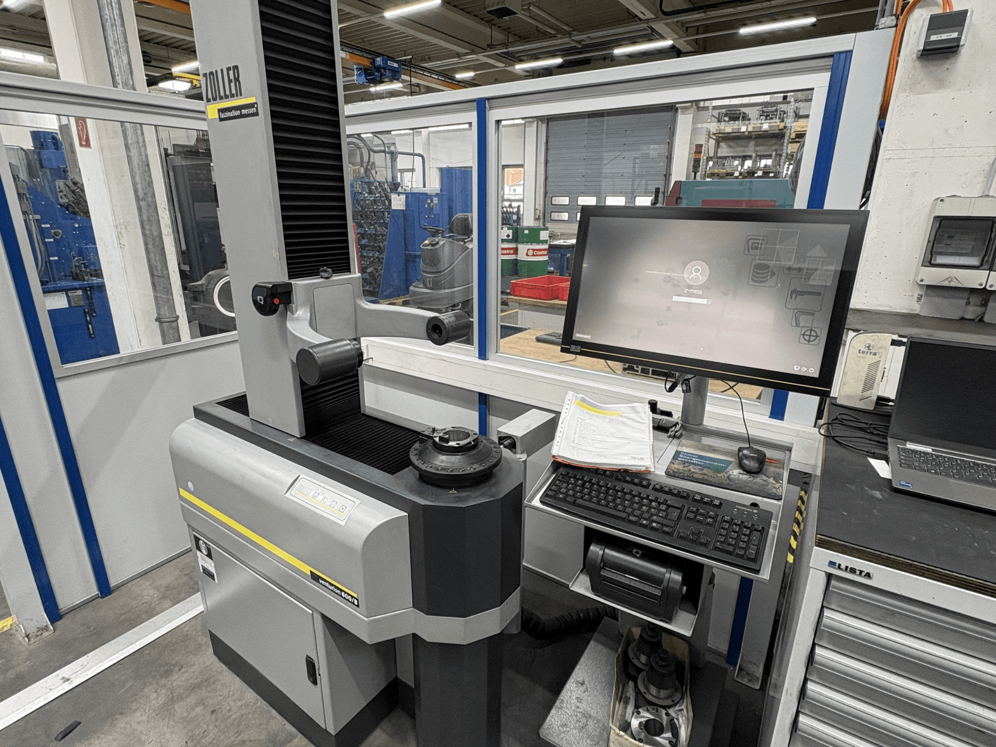 Máquina de medición óptica Zoller Venturion 600/8 en un taller, con monitor, teclado y plataforma de medición en vista lateral.