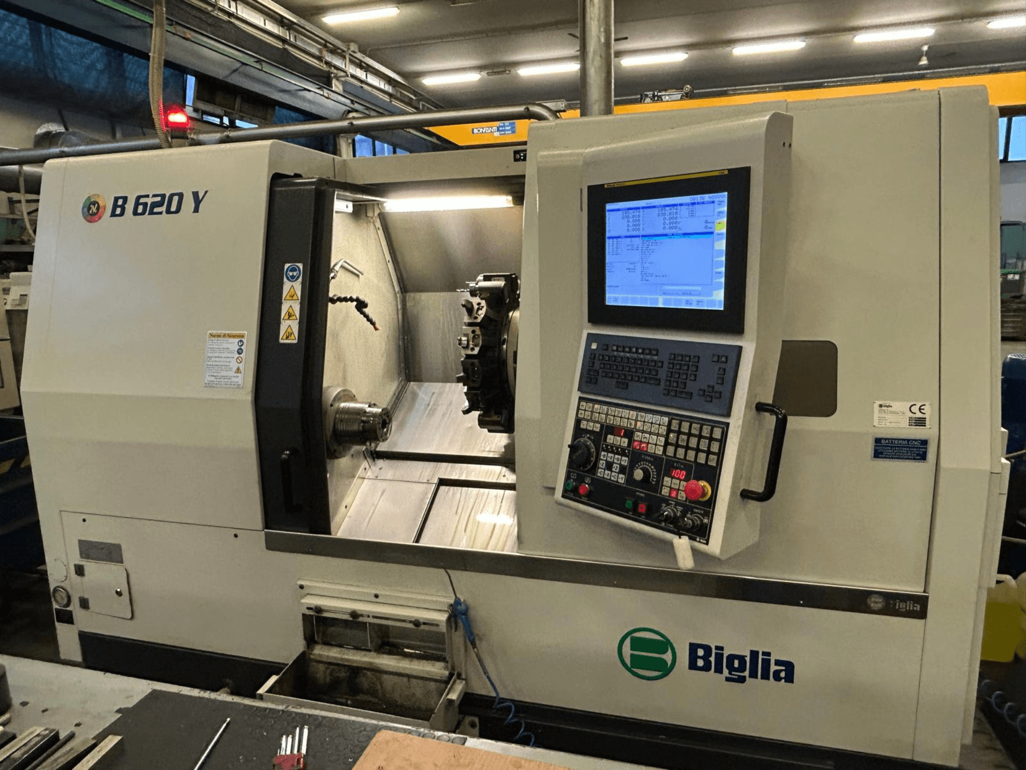 Torno CNC Biglia B 620 Y en un taller, vista frontal, mostrando el panel de control con pantalla digital y los componentes de mecanizado.