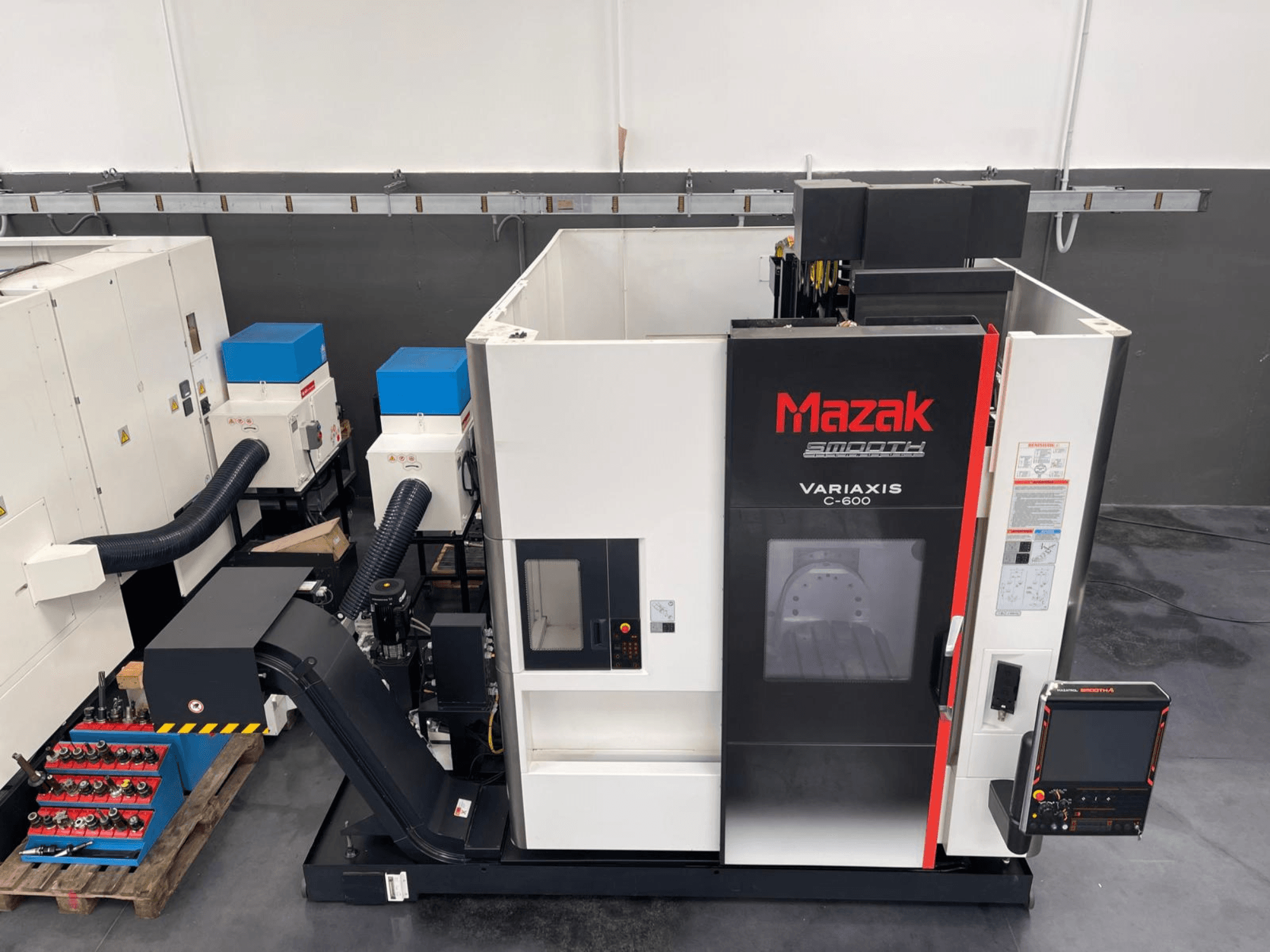 Centro de mecanizado vertical Mazak VARIAXIS C 600, vista frontal que muestra el panel de control y el almacenamiento de herramientas.