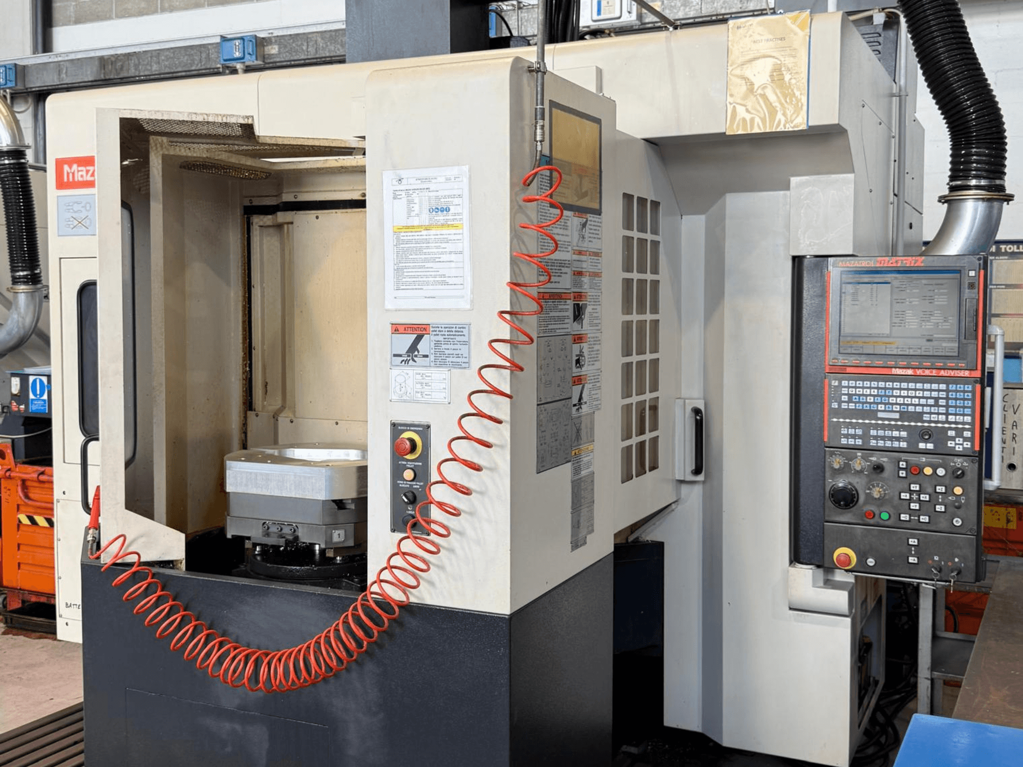 Centro de mecanizado vertical Mazak VARIAXIS I 500 en vista frontal, en el que se aprecian el panel de control, el portapiezas y la zona de almacenamiento de herramientas.