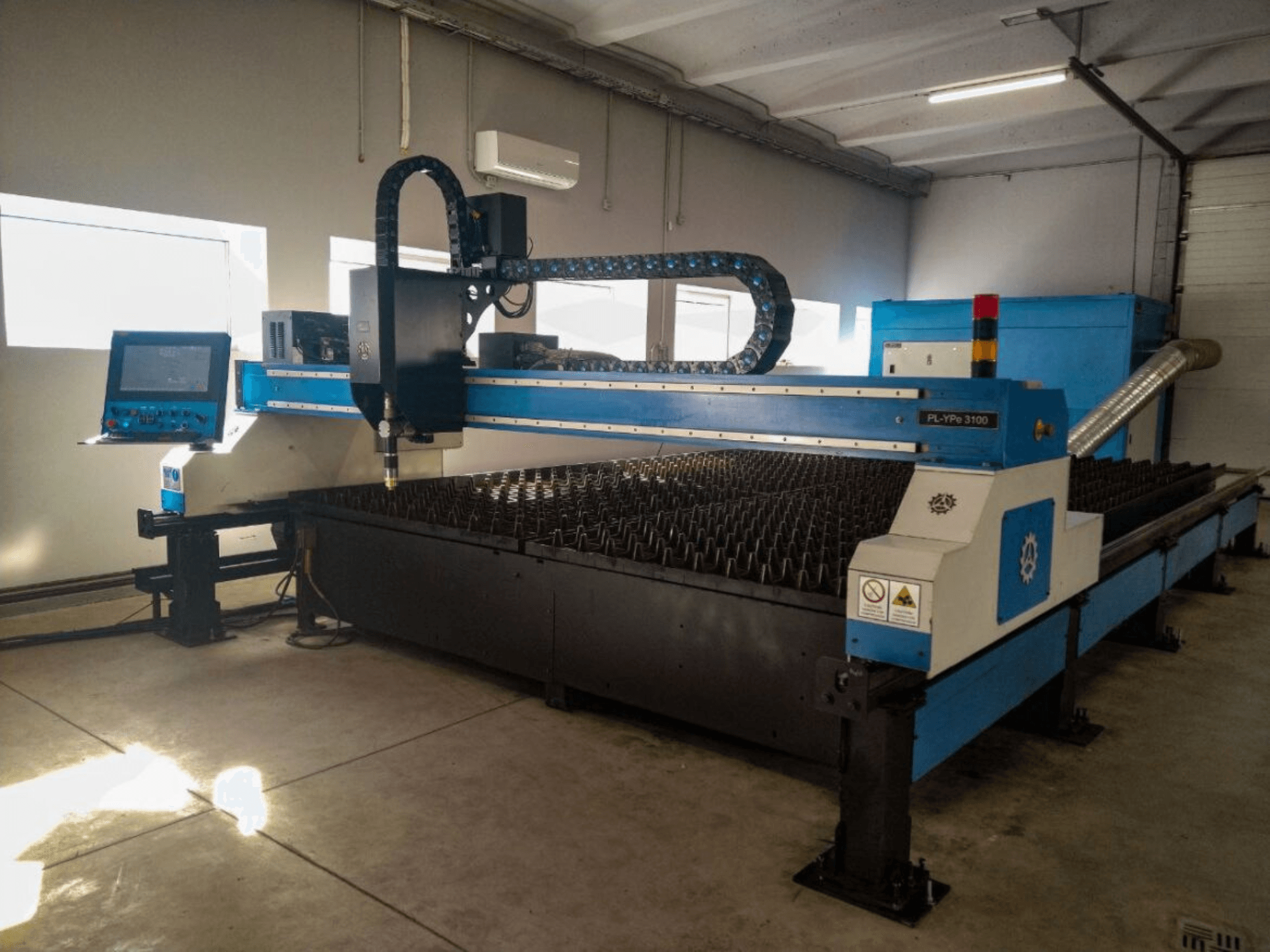 Máquina de corte CNC PL-YP© 3100 con pantalla, vista frontal, con bancada de corte de metal y sistema de guiado preciso de boquillas.