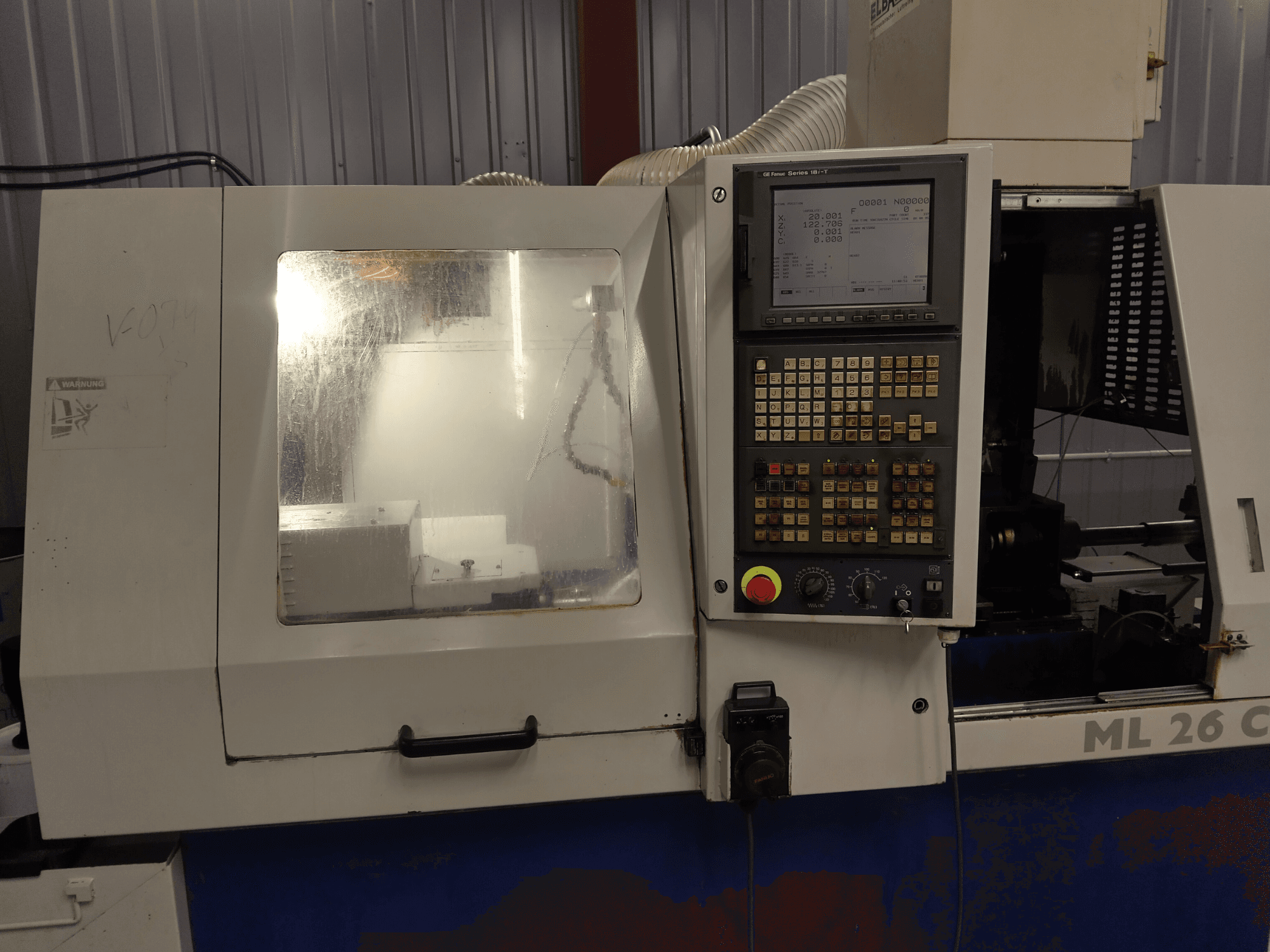 Torno suizo Maier ML 26 C1, vista frontal, en la que se aprecian el panel de control y la zona de mecanizado con una cubierta protectora transparente.