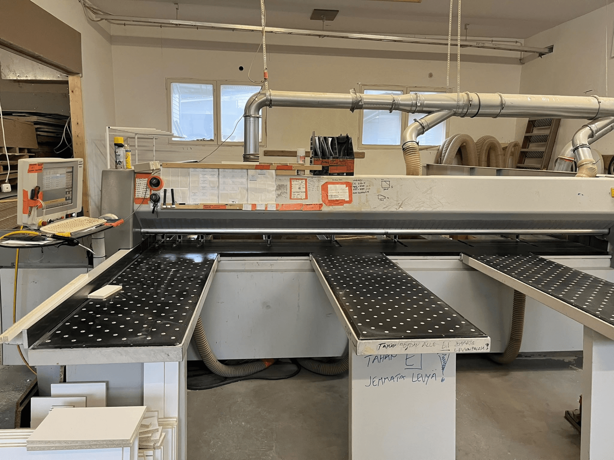 Sierra para tableros HOLZHER CUT70 en un taller, vista desde delante, en la que se aprecian la mesa de corte y el panel de control.