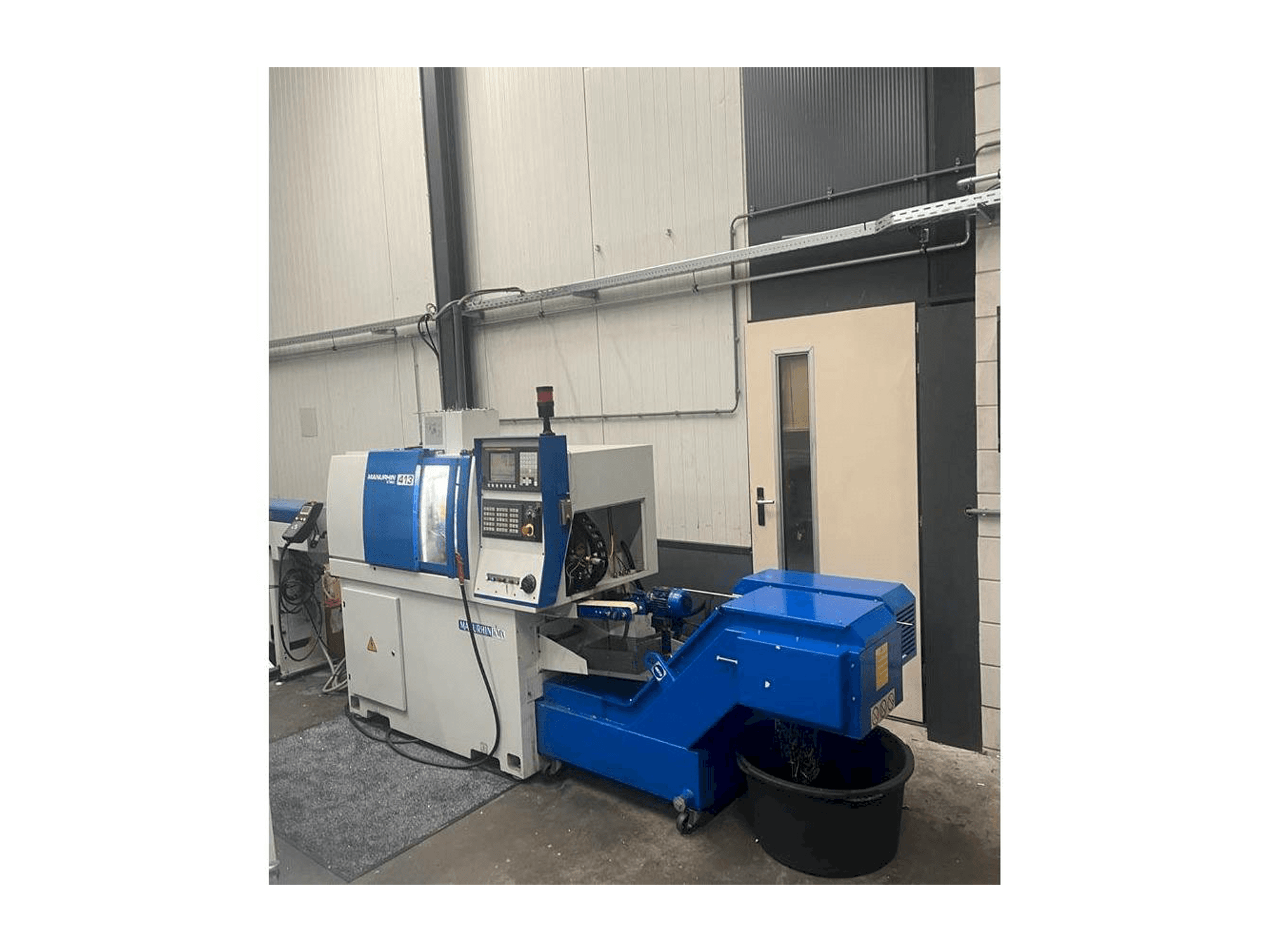 Vista frontal de la máquina Manurhin K'MX 413