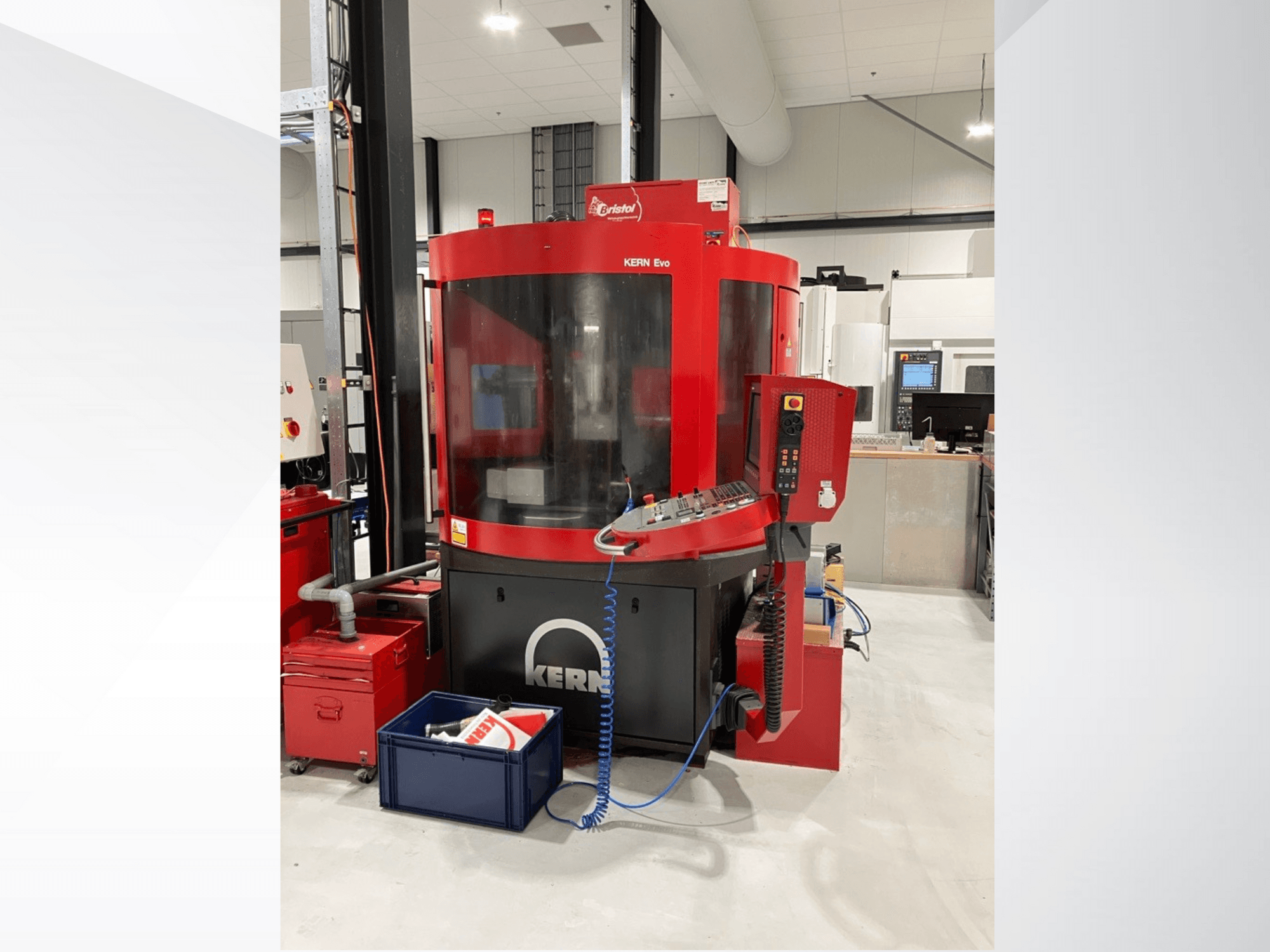 Centro de mecanizado KERN Evo en rojo y negro, vista frontal, mostrando el panel de control y el equipo circundante en un taller moderno.