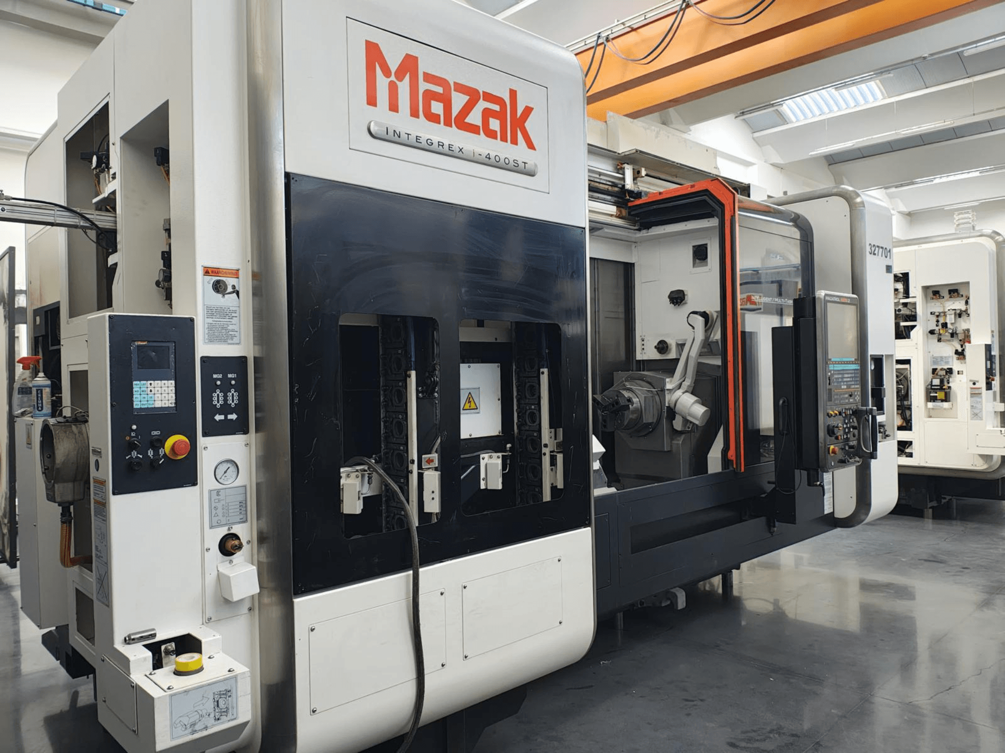 Mazak Integrex 400ST, vista frontal; máquina CNC con panel de control, husillos y brazo robótico visibles en un taller.