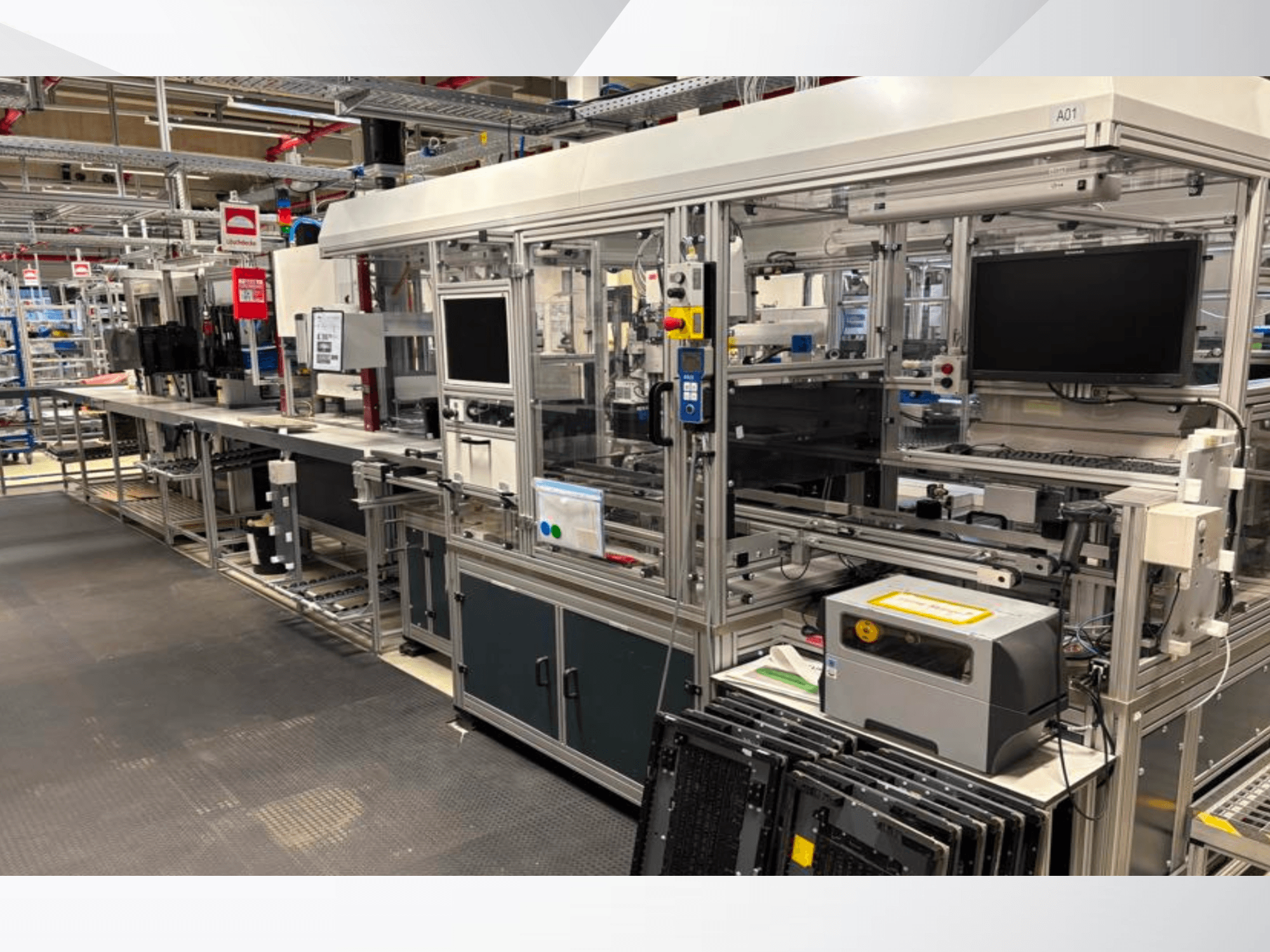 Vista lateral de la instalación del sistema de automatización AMADA Jupiter, en la que se aprecian pantallas, paneles de control y componentes de la maquinaria.