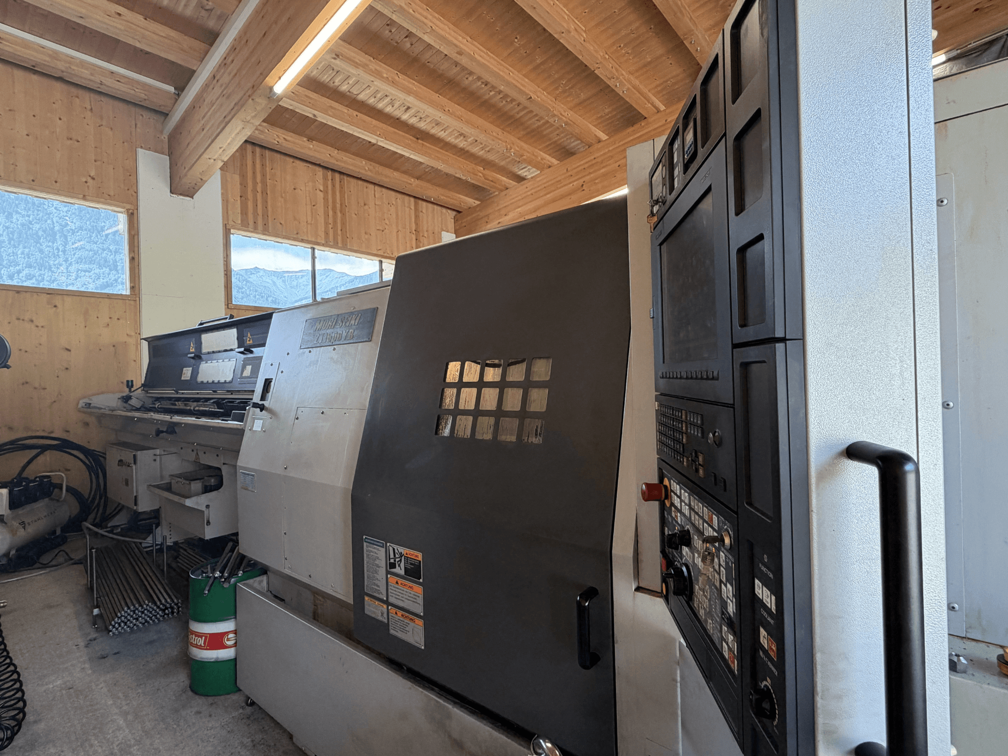 Centro de torneado y fresado MORI SEIKI ZT1500YB en un taller; vista lateral en la que se aprecian el panel de control y las características de la máquina.