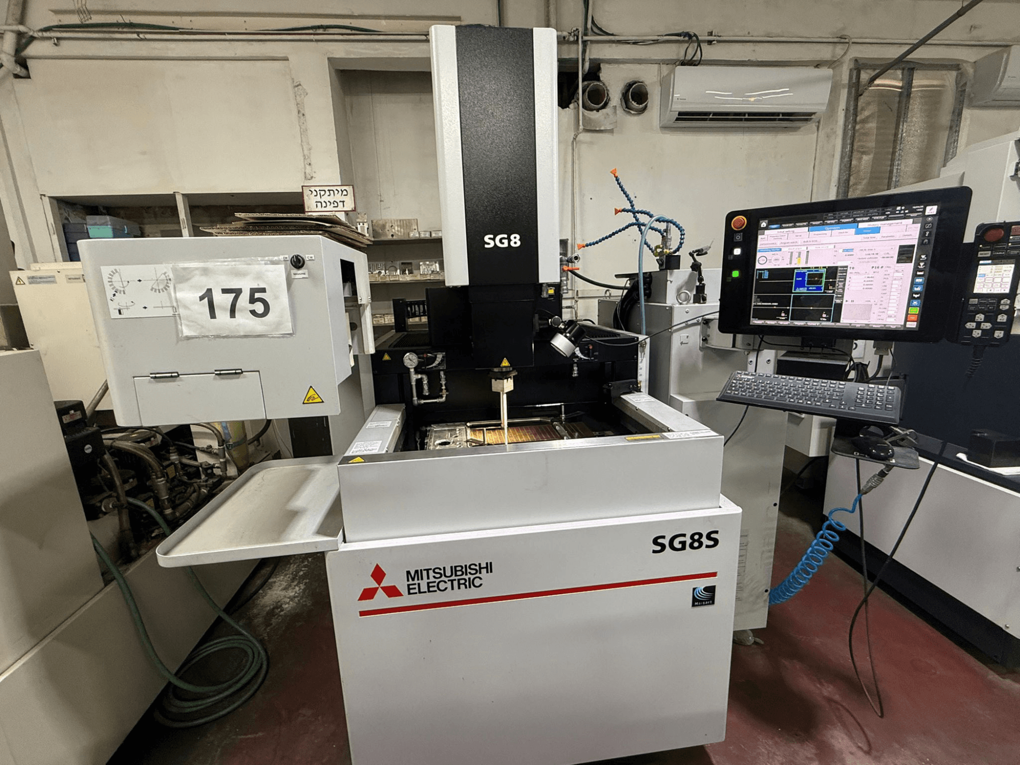 Máquina de electroerosión por penetración Mitsubishi SG8S, vista frontal con monitor y panel de control visibles; el área de trabajo muestra la configuración de la herramienta.