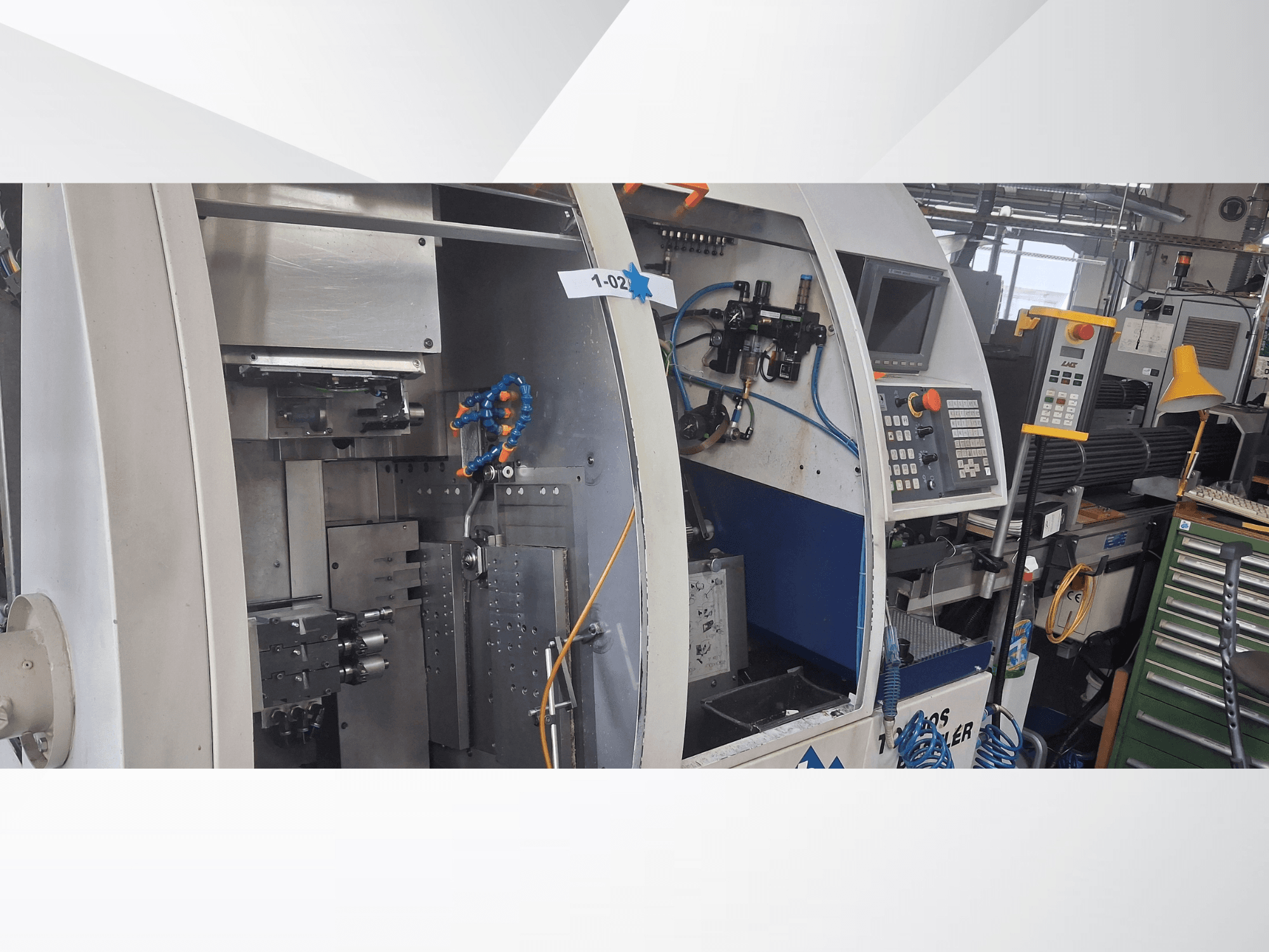 Máquina de torneado tipo suizo TORNOS DECO 2000-10, vista frontal que muestra el panel de control, el mecanismo de rotación y la configuración interna.