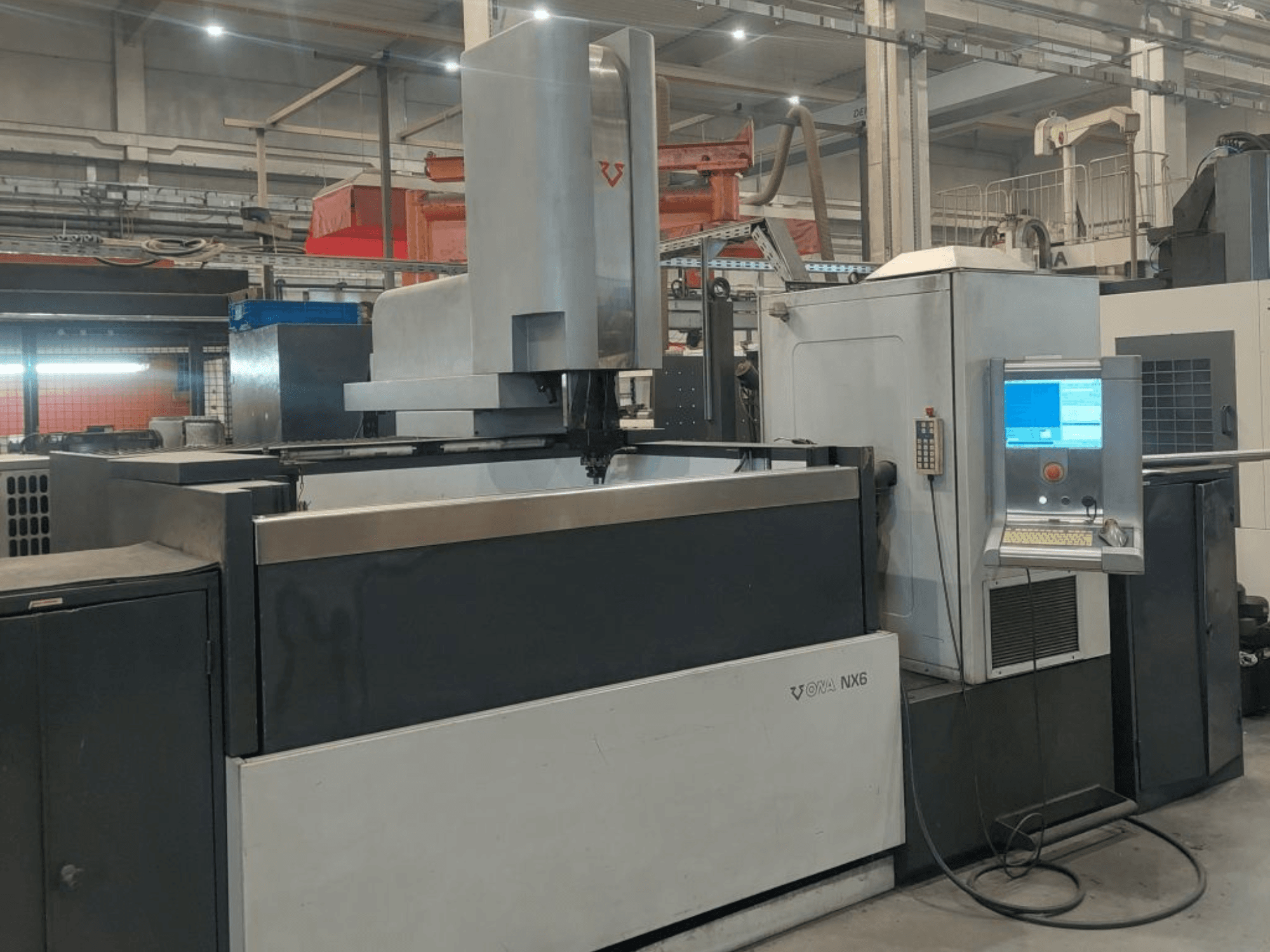 Máquina de electroerosión por penetración ONA NX6 vista de frente, que cuenta con un panel de control y una amplia zona de trabajo para el mecanizado de precisión.