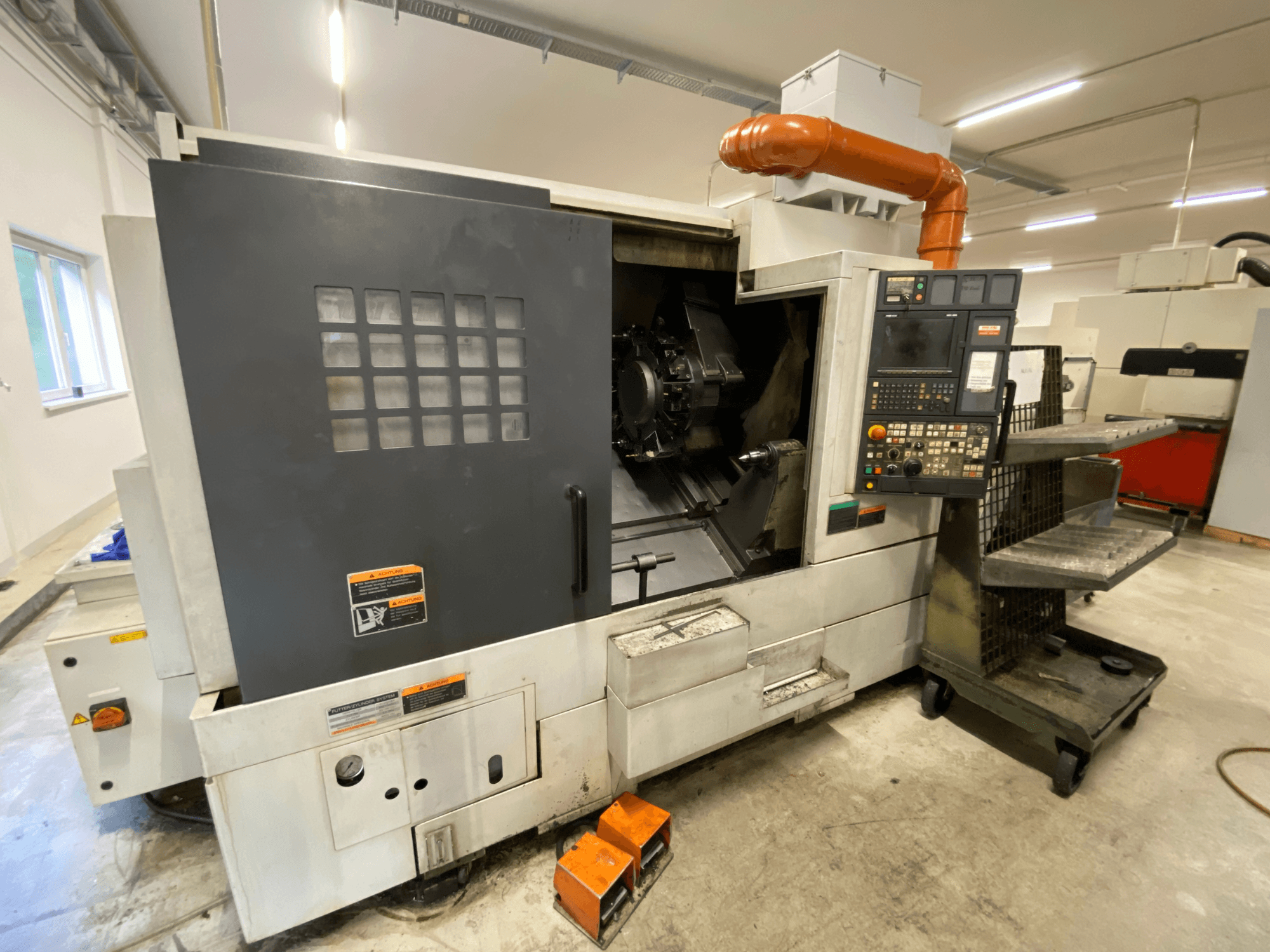 Centro de torneado y fresado DMG Mori Seiki NL2500Y/700, vista frontal en la que se aprecian el panel de control y los detalles de la carcasa de la máquina.
