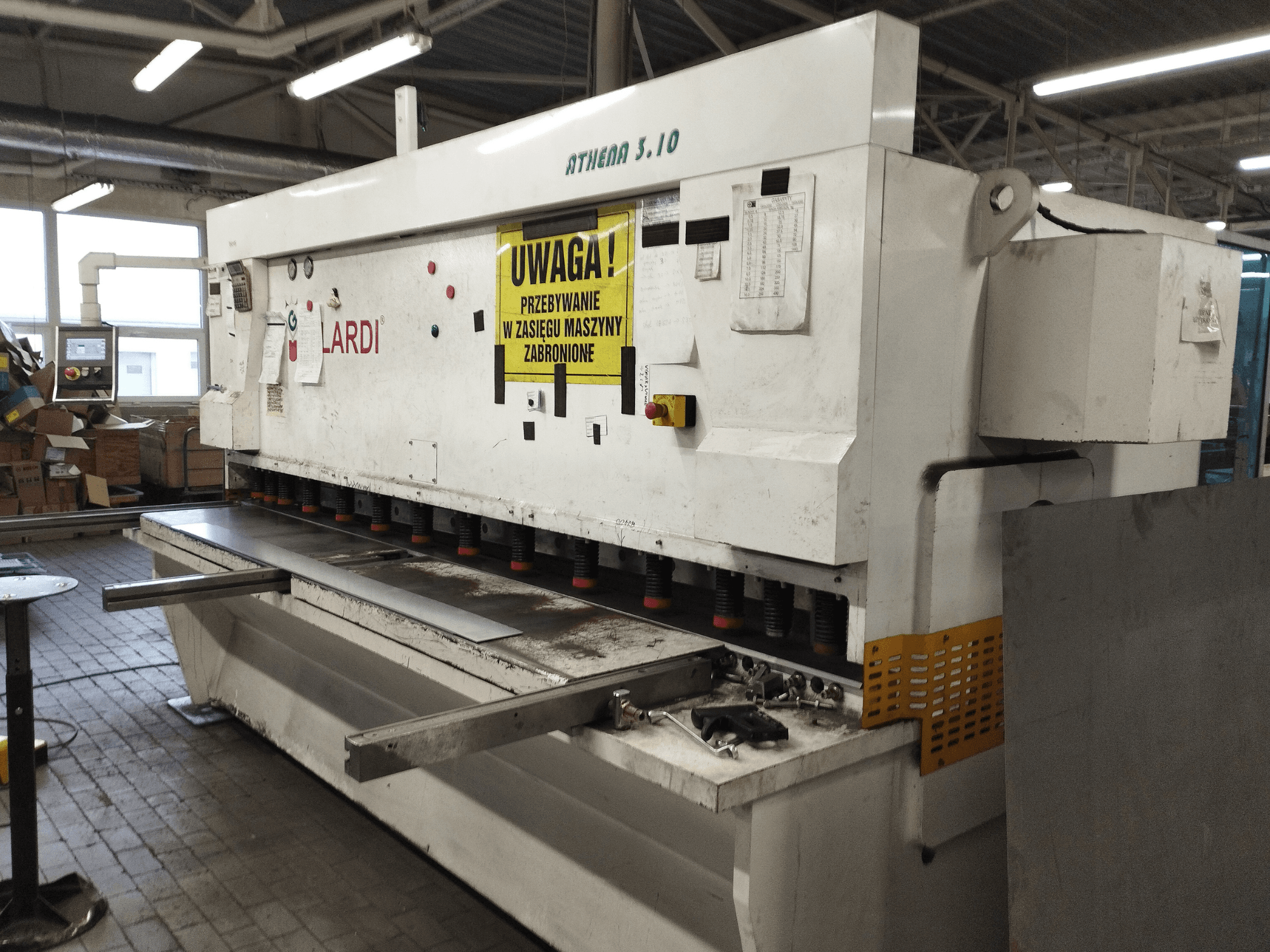 Cizalla CNC GILARDI ATHENA 3.10 en un taller, vista frontal, en la que se aprecian el panel de control y las cuchillas de corte.