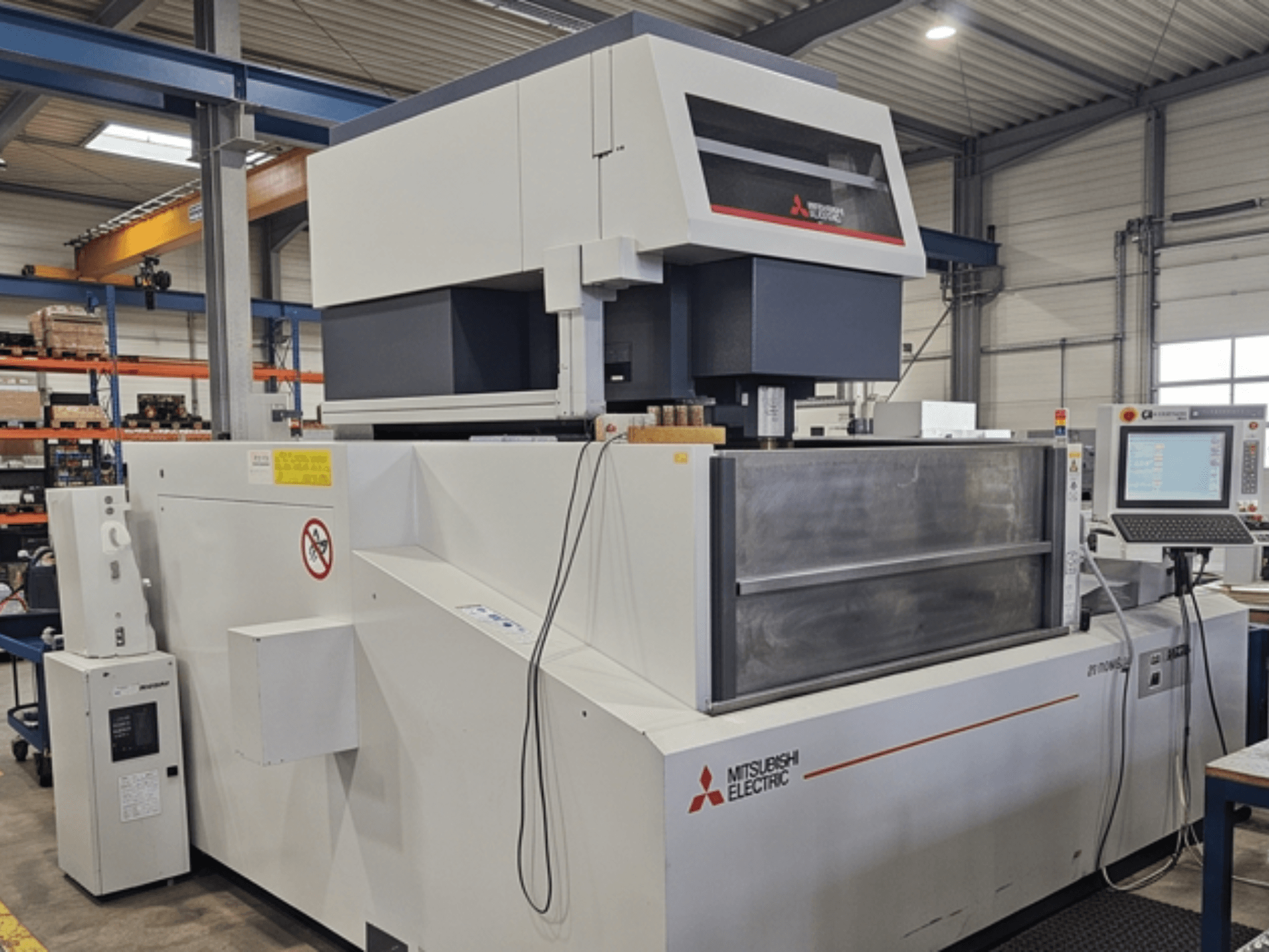 Máquina de electroerosión por hilo Mitsubishi MV-4800, vista frontal, en la que se aprecian el panel de control y la zona de trabajo en un entorno industrial.
