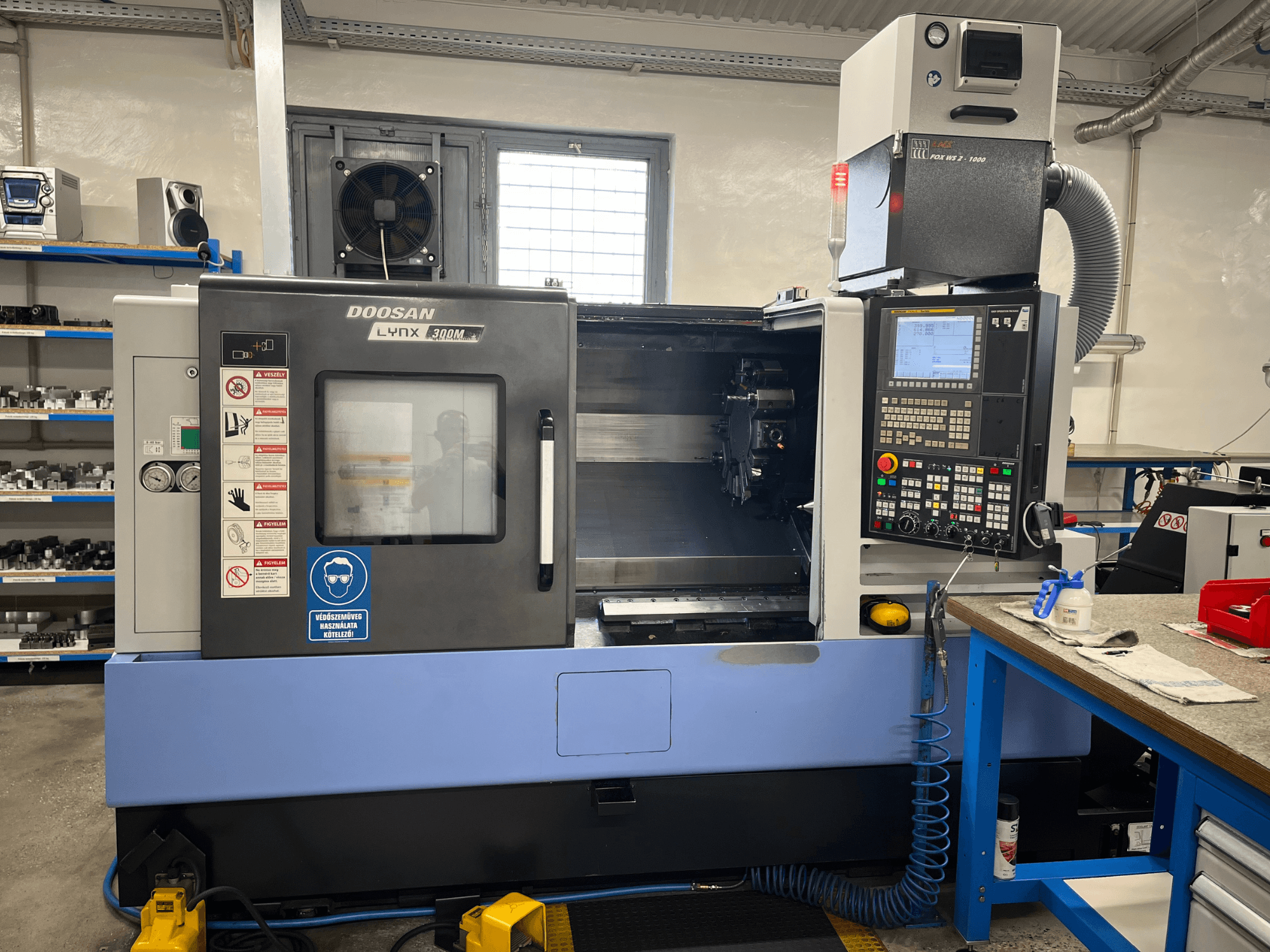Torno horizontal DOOSAN LYNX 300M, vista frontal, en la que se aprecian el panel de control y los componentes operativos.